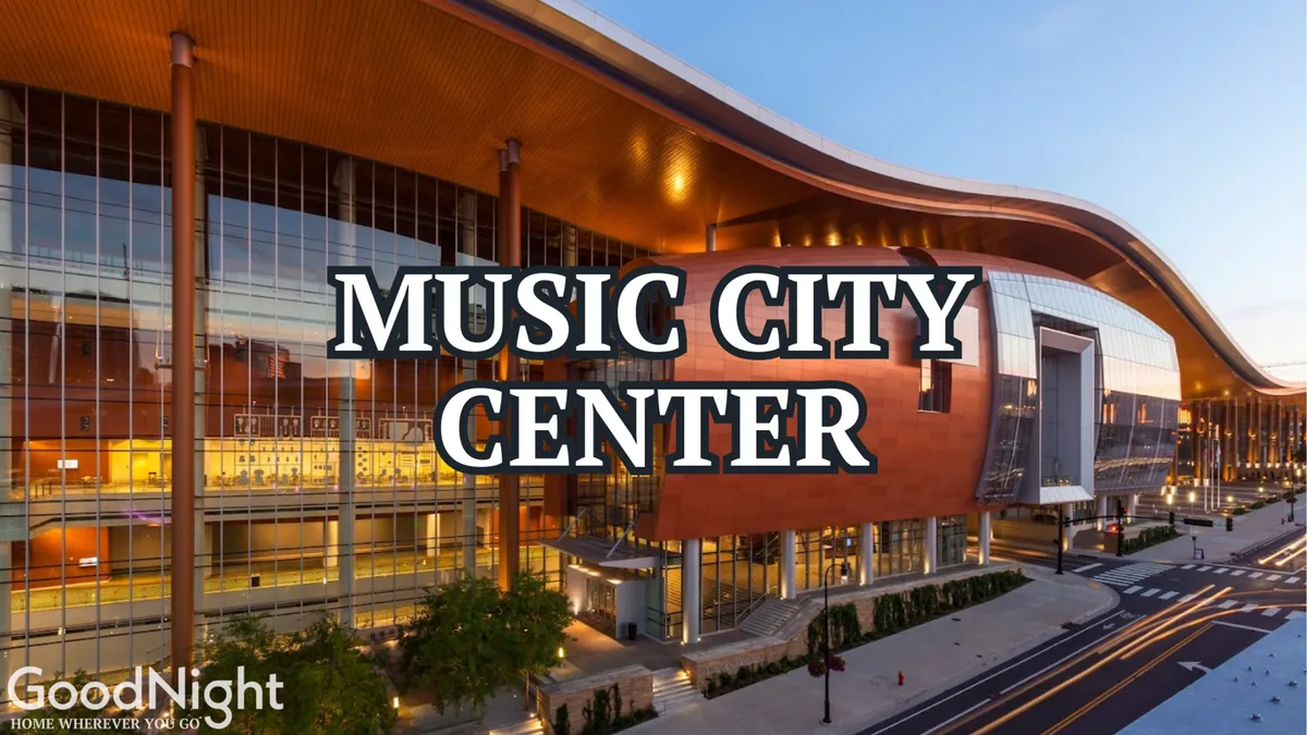 The image captures the striking exterior of the Music City Center, a major Nashville convention venue, with its sweeping architecture framed by landscaped streets. This bustling area suggests proximity to major business and entertainment hubs.