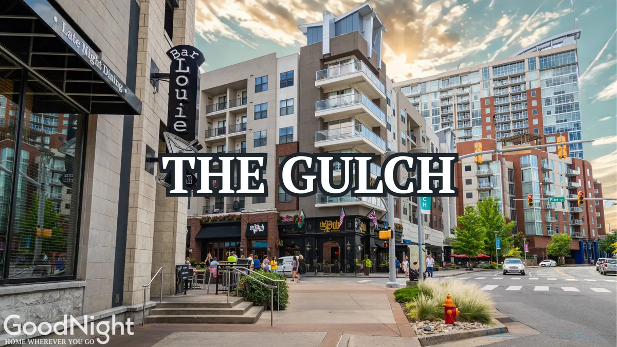 The scene spotlights the Bar Louie signage amid modern apartment buildings and visible street activity, evoking the contemporary, urban lifestyle and vibrant nightlife just outside the property. People dine at outdoor cafes and enjoy the energetic atmosphere.
